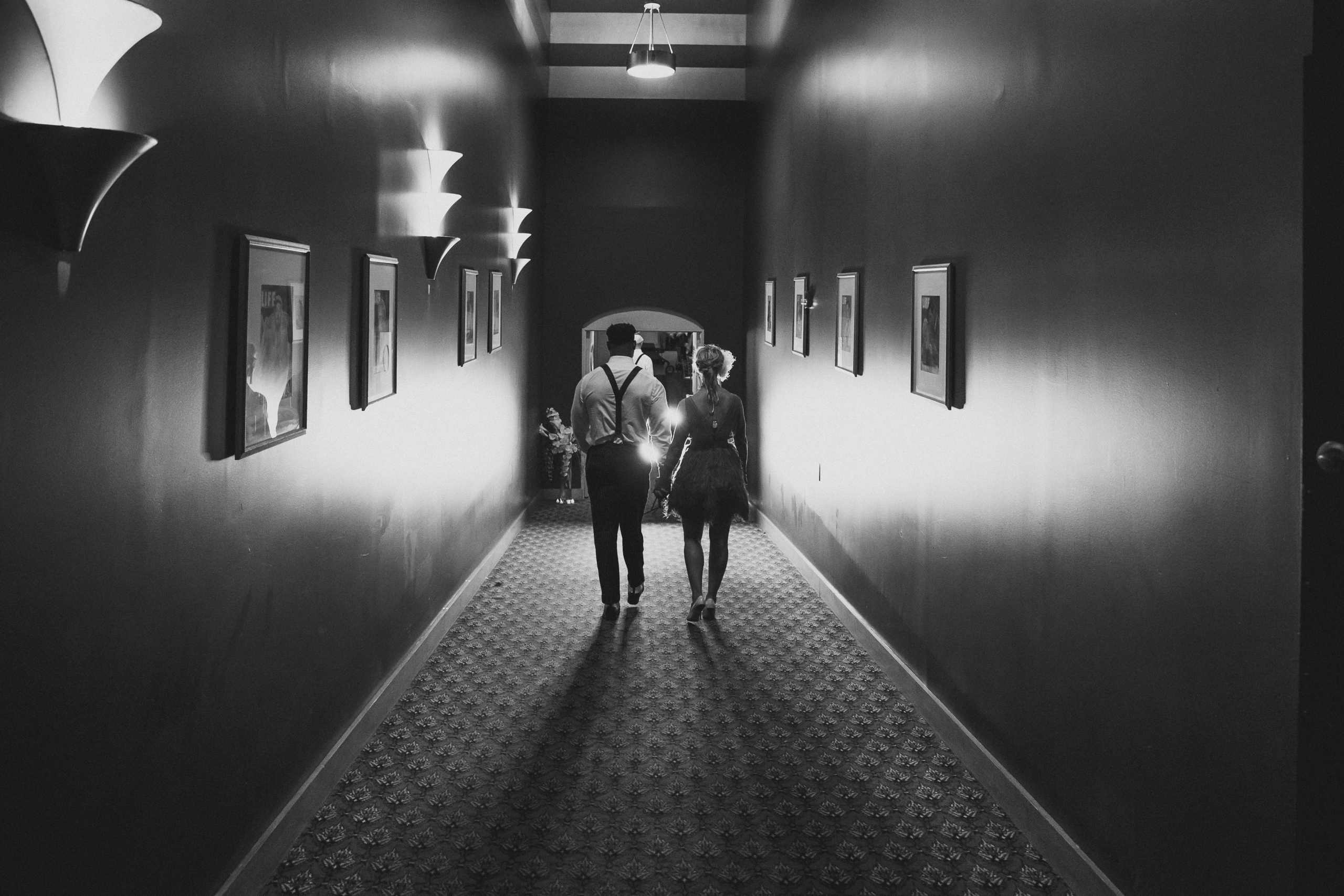 American Theater Wedding Hallway Bride and groom walking through the dramatic Art Deco hallway at the American Theater in Charleston