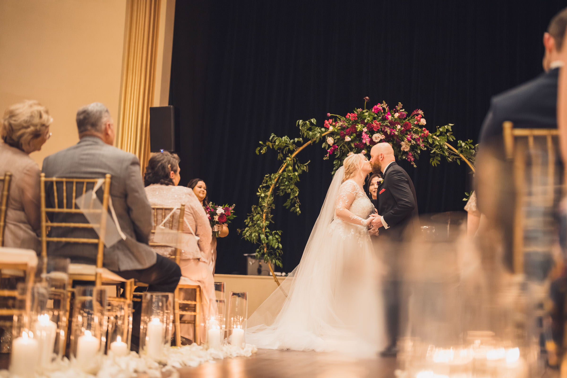 American Theater Ceremony First Kiss Bride and groom sharing their first kiss during a candlelit wedding ceremony at the American Theater