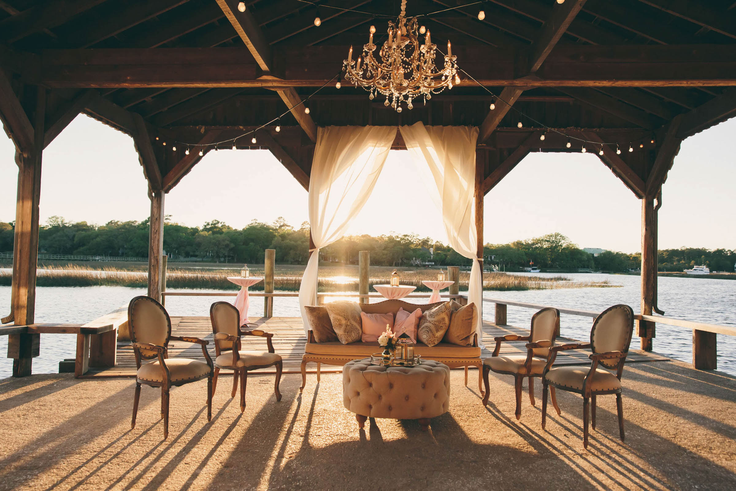 Boone Hall Cotton Dock Reception Waterfront lounge seating beneath the open-air Cotton Dock at Boone Hall Plantation
