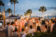 Wedding guests surround the newlyweds with sparklers during an outdoor waterfront reception at Charleston Harbor Resort & Marina.