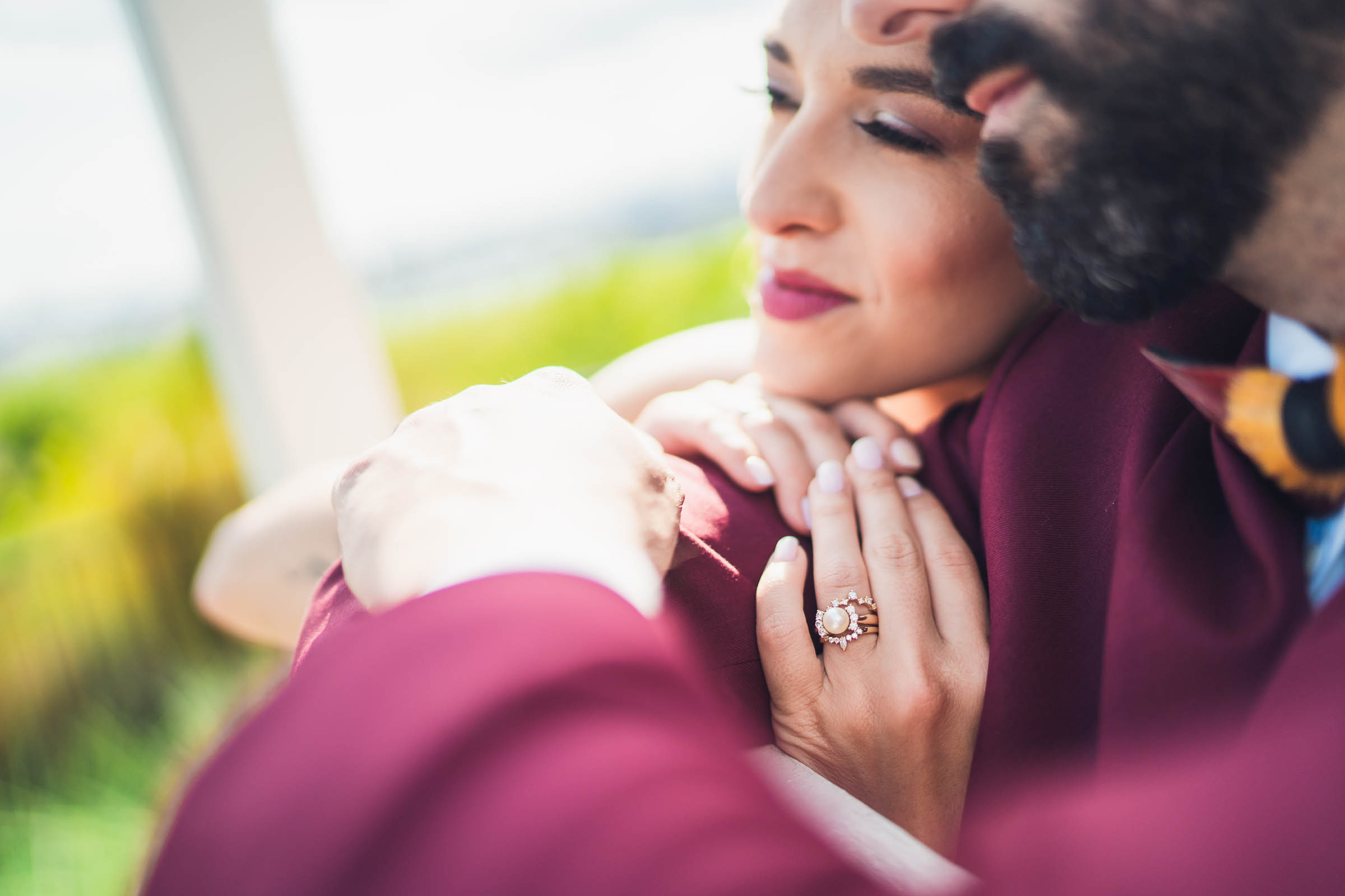 Close-up of the bride’s wedding rings as she embraces the groom after their Charleston Harbor wedding.
