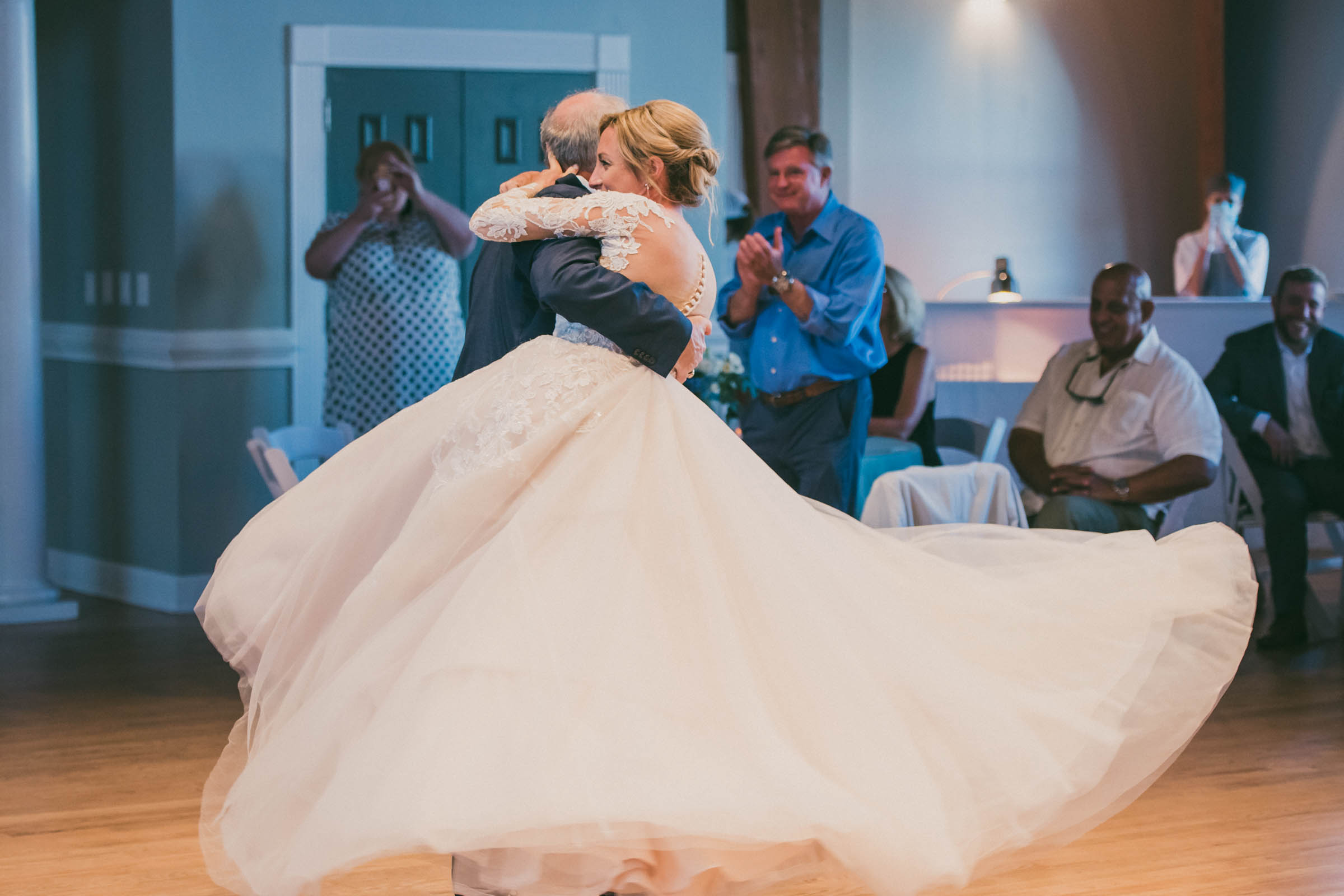 Bride being lifted and spun on the dance floor at the Citadel Beach House.