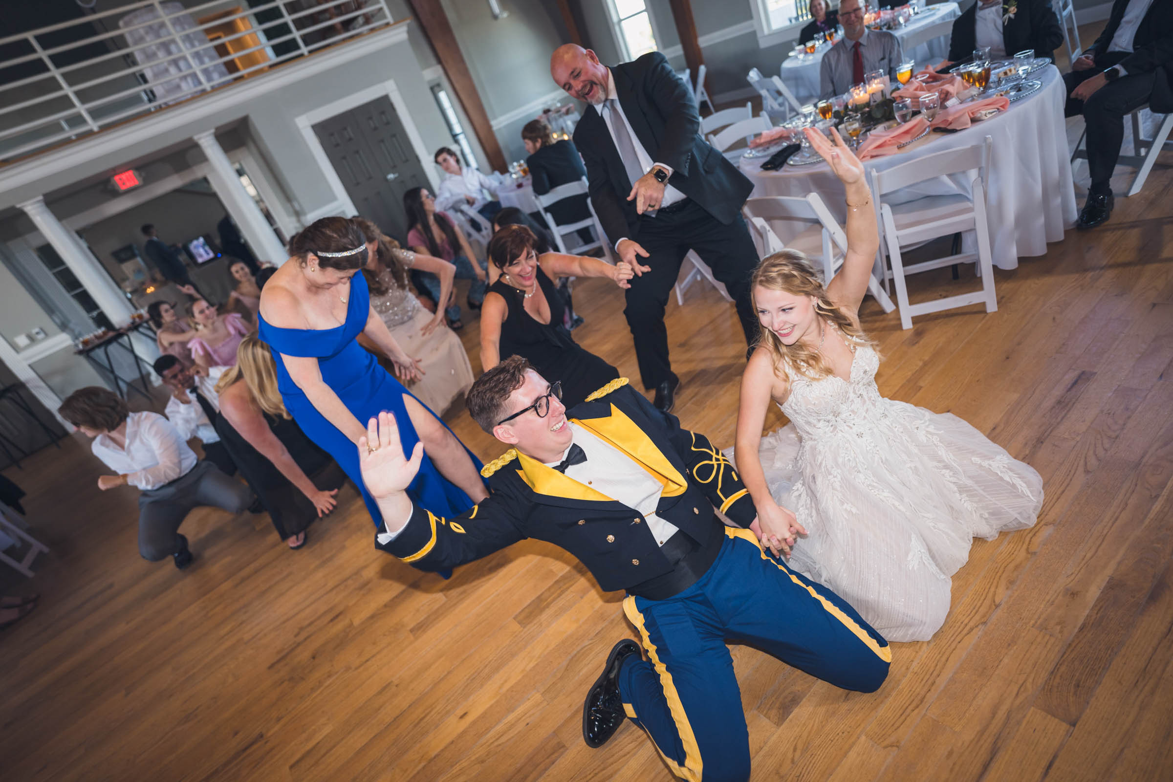 Bride and groom dancing on the floor during their Citadel Beach Club reception, with the groom wearing a U.S. Army blue mess dress uniform.