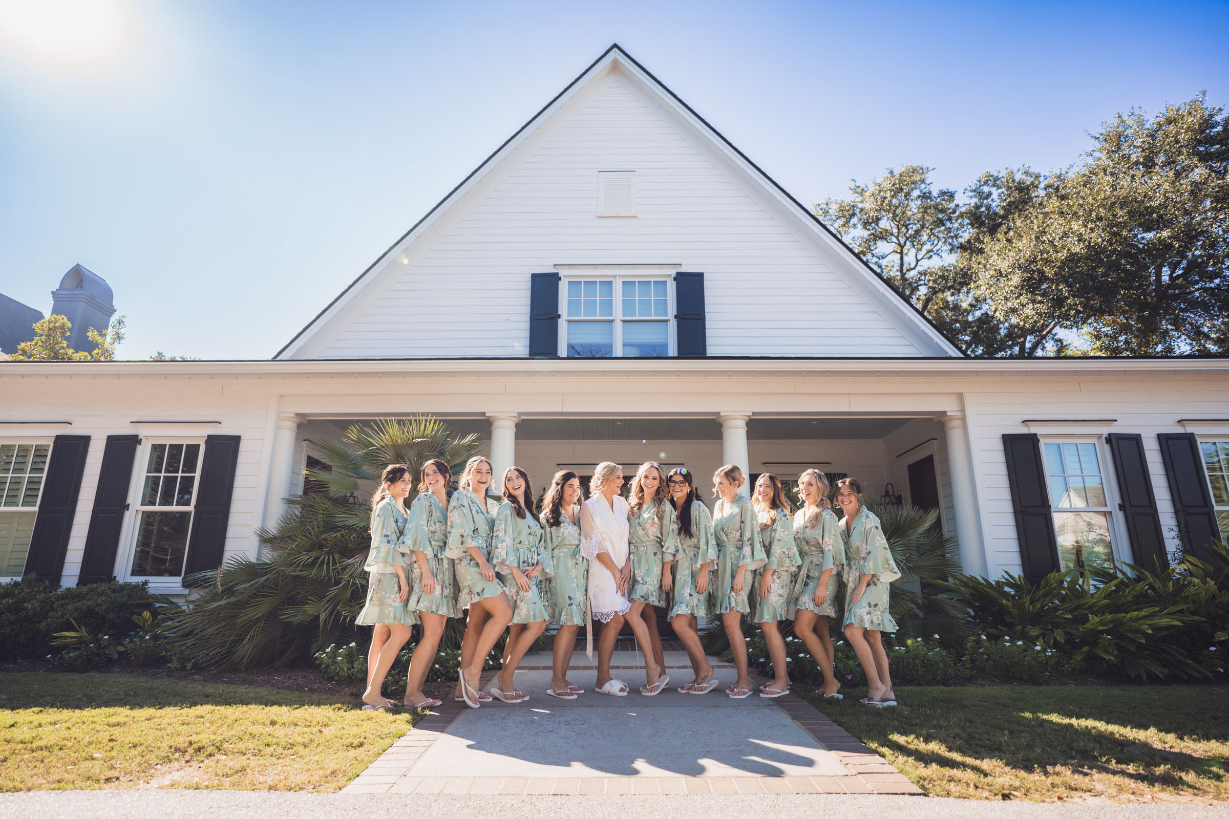 Bridesmaids Getting Ready at Daniel Island Club Bride and bridesmaids in matching robes gathered outside one of the cottages at Daniel Island Club before the wedding.