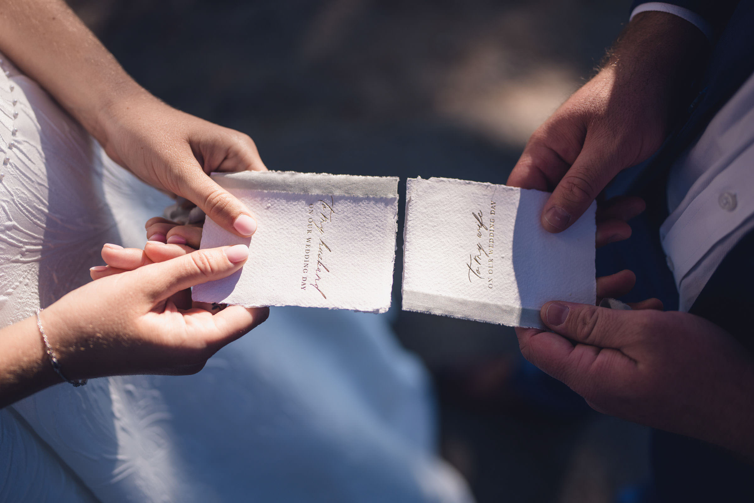 Wedding Vows at Daniel Island Club Close-up of a bride and groom holding handmade vow books during their outdoor Daniel Island Club wedding ceremony.
