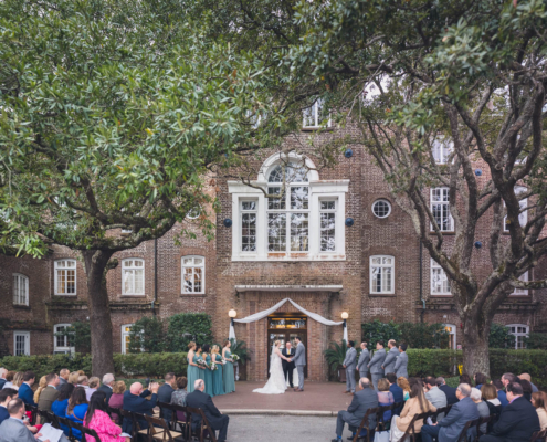 Wedding ceremony beneath the live oaks of the Historic Rice Mill in Charleston.