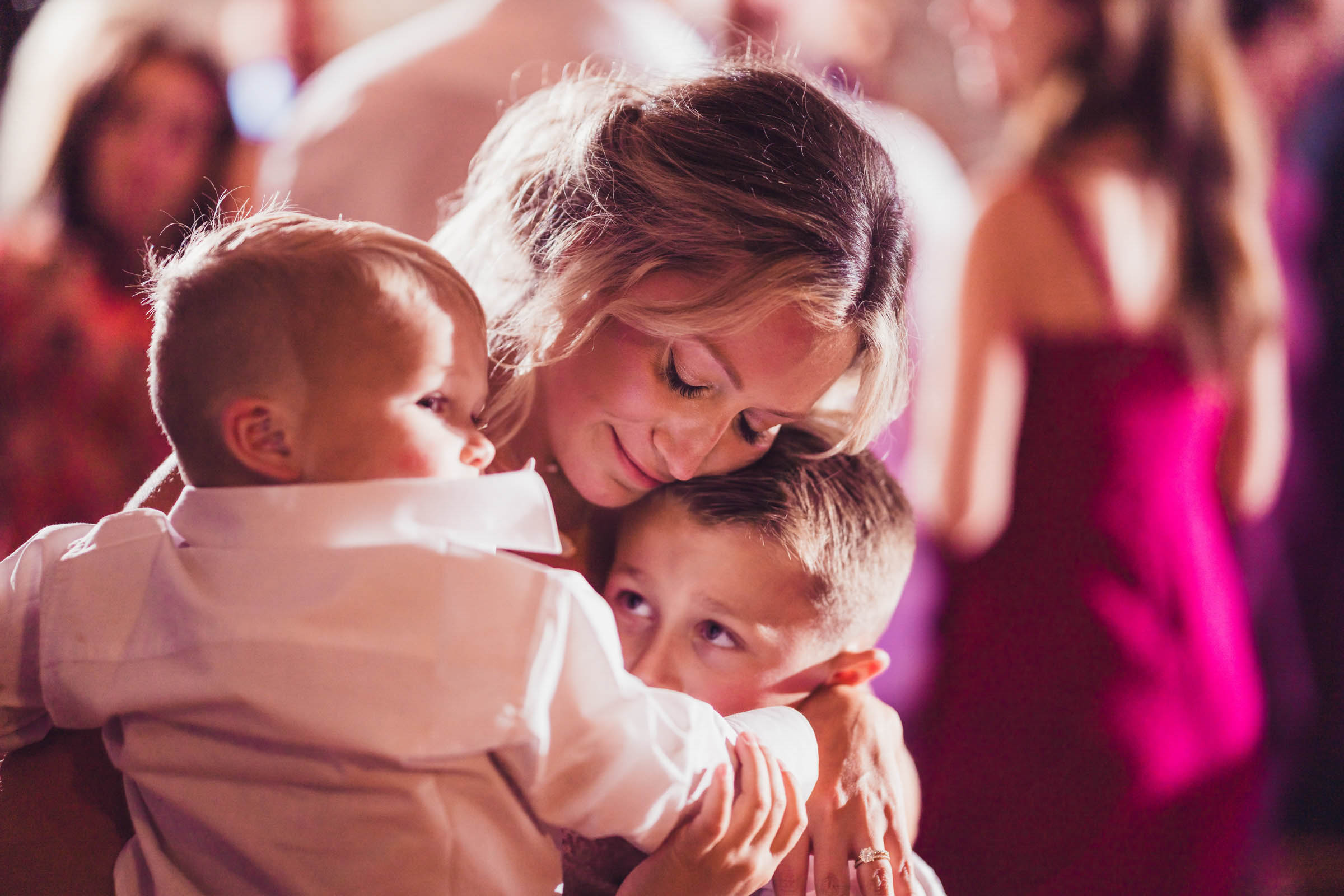 Bride with Children at the Historic Rice Mill Bride hugs two young boys on the dance floor during her Historic Rice Mill wedding reception.