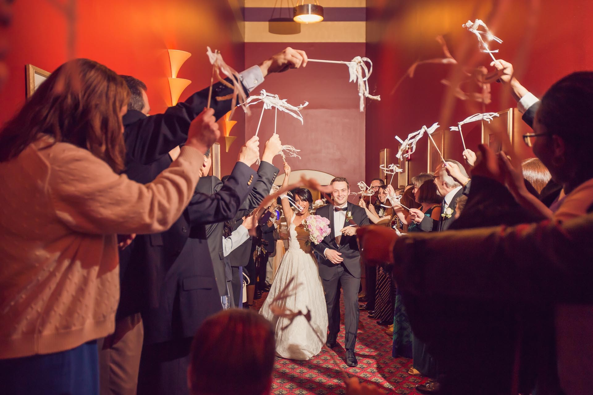 American Theater Wedding Exit Newlyweds walking through a ribbon send-off with their wedding guests inside the American Theater in Charleston