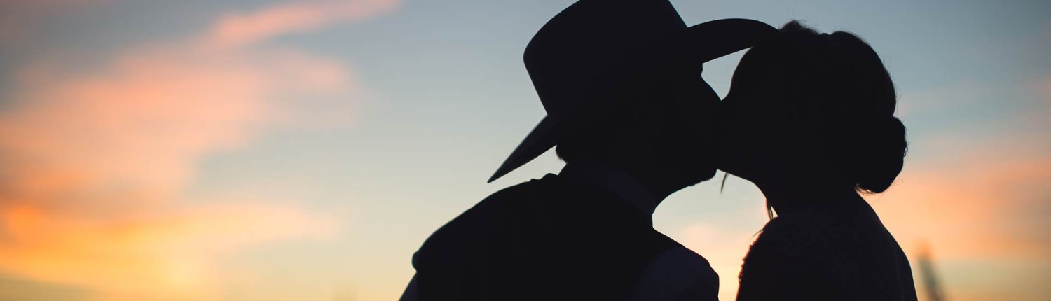 cowboyhat sunset portrait bride and groom