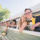 Bride and Groom and Wedding Party Leaning out of Vintage Bus after Wedding