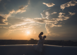 Silhouette of Bride and Groom on Hotel Rooftop at Sunset