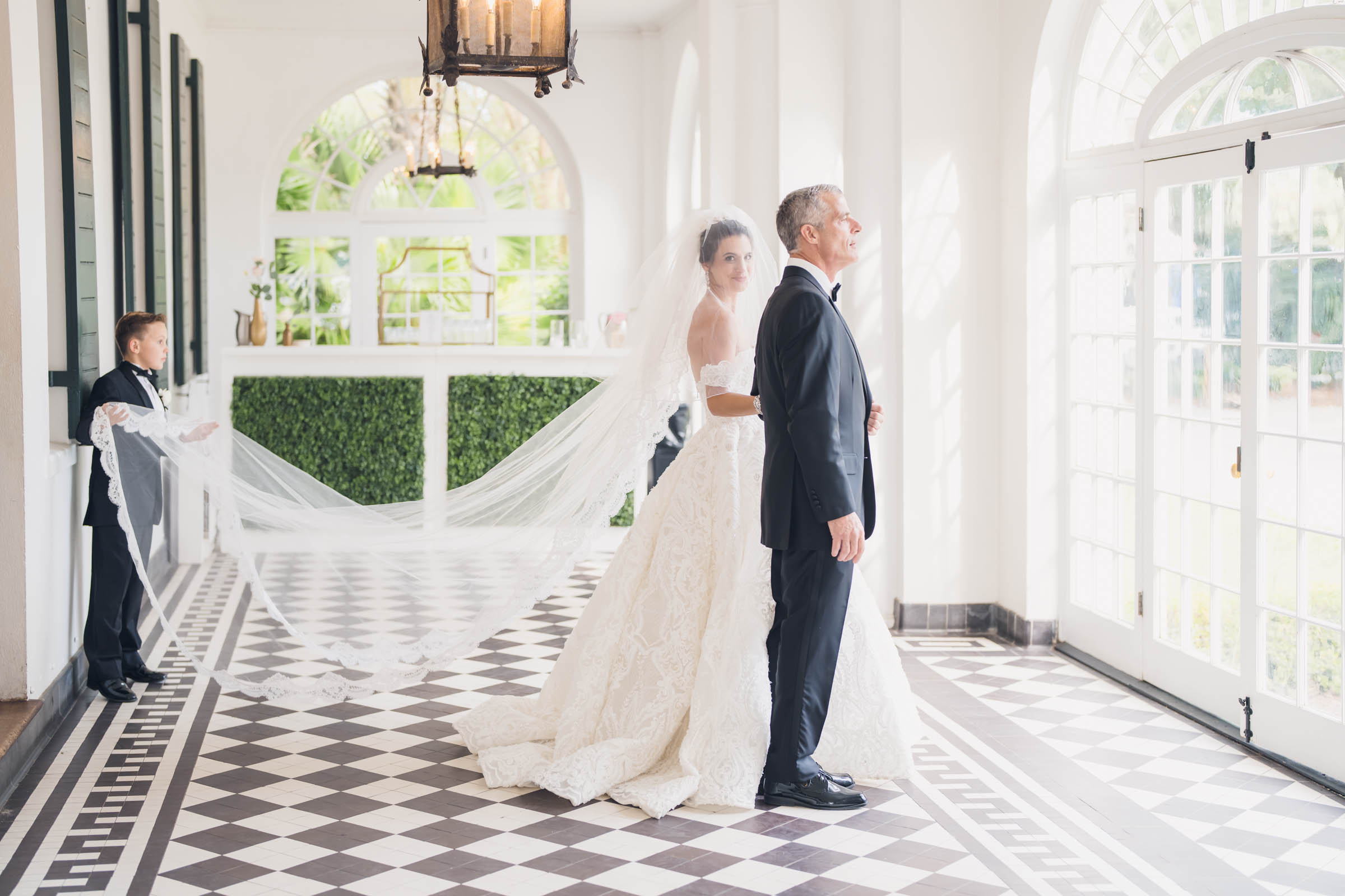 The bride with her Dad & her nephew the veil bearer waiting for the big moment at Lowndes Grove in Charleston, South Carolina.