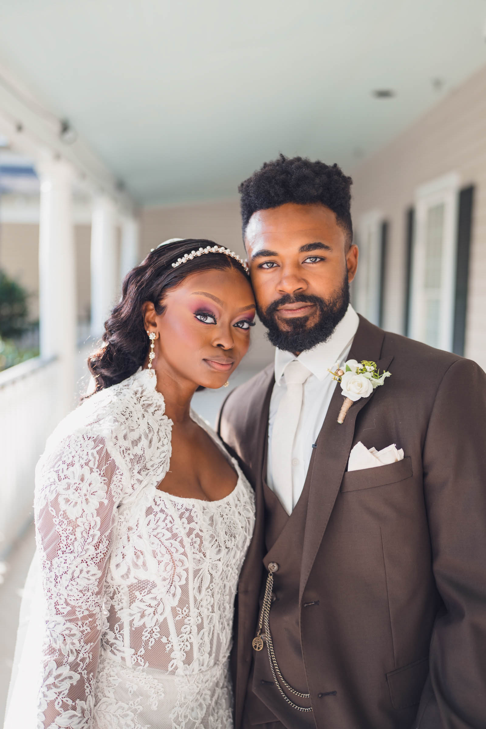 A quiet, intense portrait of the couple looking at the camera, minutes after getting married.