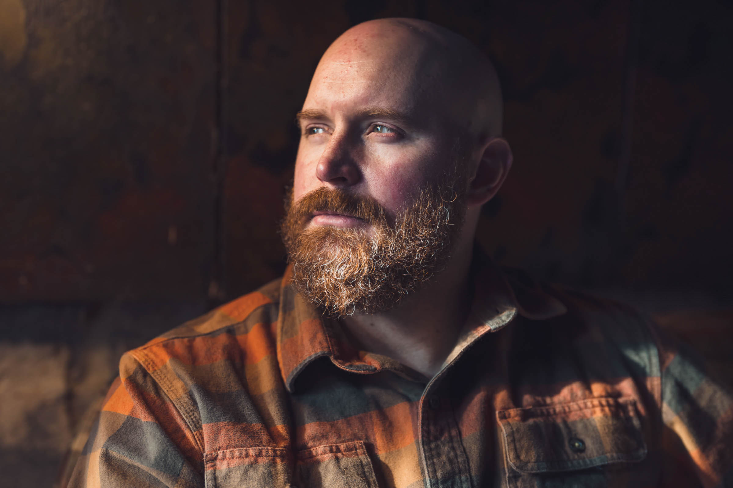 A close up portrait of a groom in his game day outfit, before putting on the tux.